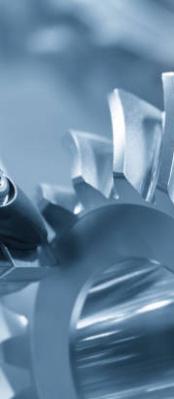 Close up the chip insert tool on the lathe machine cutting the gear parts in the light blue scene. The high precision mechanical parts manufacturing concept.
